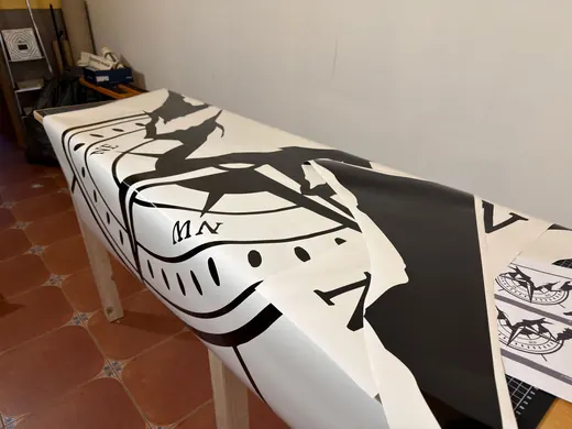 Ein langer Tisch ist mit einer schwarz-weißen Tischdecke bedeckt, die ein abstraktes Design mit geometrischen und grafischen Mustern zeigt